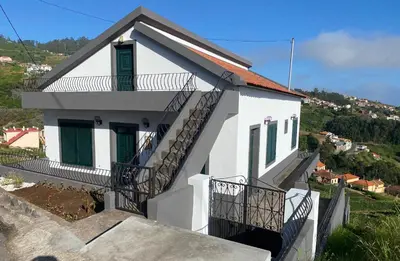 two chairs and a table on a balcony with a view at Country house in Arco da Calheta