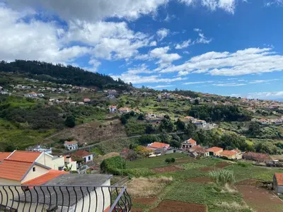 a bathroom with a shower and a toilet and a sink at Country house in Arco da Calheta