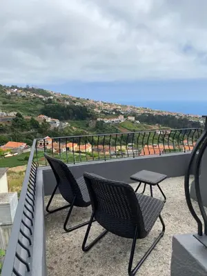 a small town on a hill with houses at Country house in Arco da Calheta