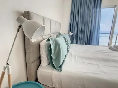 a bedroom with a bed with a lamp and a pillow at Villa Omar by LovelyStay in Canhas