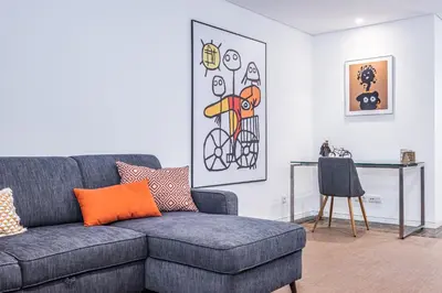 a living room with a couch and a table at Casa do Batente - By WeHost in Funchal