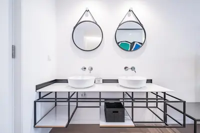 a bathroom with two sinks and two mirrors at Casa do Batente - By WeHost in Funchal