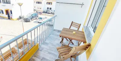 a balcony with a table and two chairs on a balcony at Caroline's in Vila do Bispo
