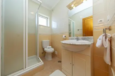 a bathroom with a sink and a shower and a toilet at B73 - Luz Sun Holiday Apartment in Lagos