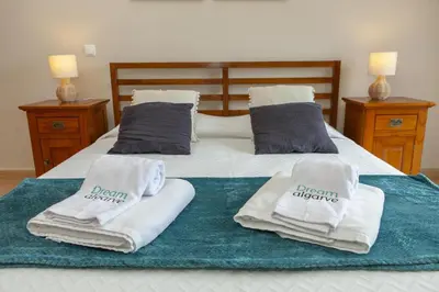 a bed with towels and pillows on top of it at B73 - Luz Sun Holiday Apartment in Lagos