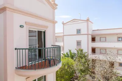 a balcony of a white building with a view of two buildings at B73 - Luz Sun Holiday Apartment in Lagos