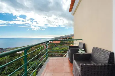 a balcony with two chairs and a view of the ocean at Jay Paradise in Santa Cruz