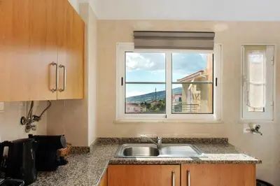 a kitchen with a sink and a window at Jay Paradise in Santa Cruz