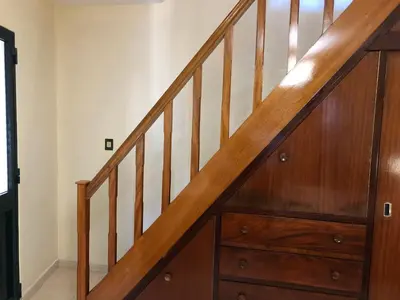 a staircase with wooden railings and a chest of drawers at Casa Bica do Cais - By the Sea in Paul do Mar