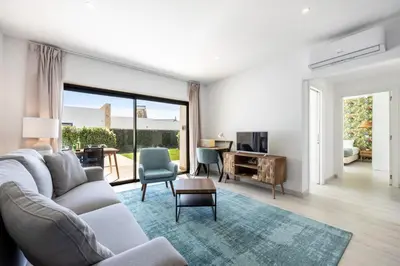a living room with a couch and a tv at Villa Drop in in Sagres