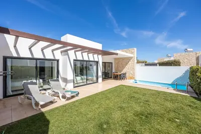 a yard with two chairs and a swimming pool at Villa Drop in in Sagres
