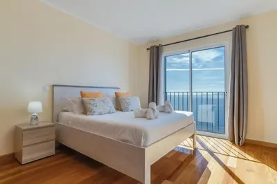 a bedroom with a large bed and a large window at Casa Morena by Atlantic Holiday in Santa Cruz