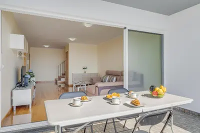 a living room with a white table and chairs at Casa Morena by Atlantic Holiday in Santa Cruz