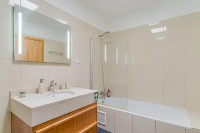 a bathroom with a sink and a mirror and a tub at Casa Morena by Atlantic Holiday in Santa Cruz