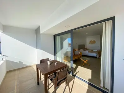 a room with a table and chairs and a bedroom at Estúdio com Fantástica Vista Mar - Praia da Luz in Luz