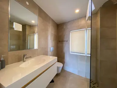 a bathroom with a sink and a toilet and a mirror at Estúdio com Fantástica Vista Mar - Praia da Luz in Luz