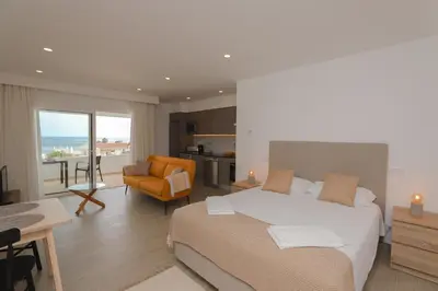 a bedroom with a bed and a kitchen and a living room at Estúdio com Fantástica Vista Mar - Praia da Luz in Luz
