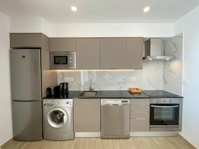a kitchen with a refrigerator and a washer at Estúdio com Fantástica Vista Mar - Praia da Luz in Luz