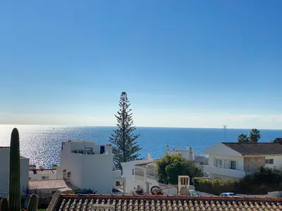 a view of the ocean from the roofs of houses at Estúdio com Fantástica Vista Mar - Praia da Luz in Luz