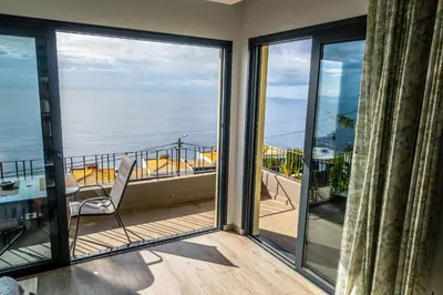 a balcony with a view of the ocean at Apartamento Domingos in Arco da Calheta