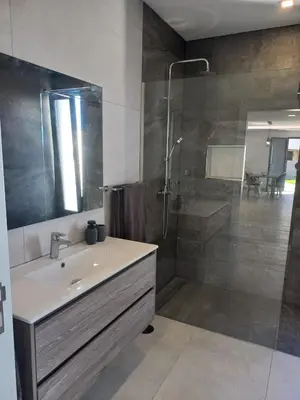 a bathroom with a sink and a shower at Apartamento Domingos in Arco da Calheta