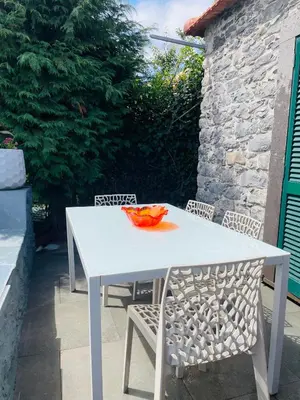 a white table and chairs with a bowl on it at The Farm House.23 in Funchal