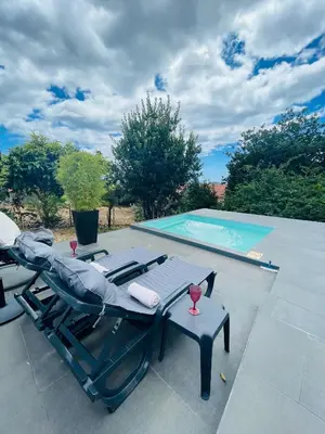 a swimming pool with a chaise lounger and a table and a pool at The Farm House.23 in Funchal