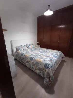 a bedroom with a bed with a quilt on it at Friendly house in Funchal