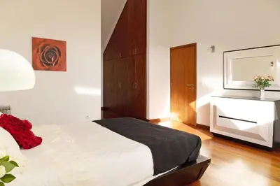 a bedroom with a large bed with two night stands at Villa Aurélio in Campanário