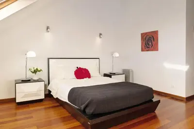 a bedroom with a large bed and two windows at Villa Aurélio in Campanário