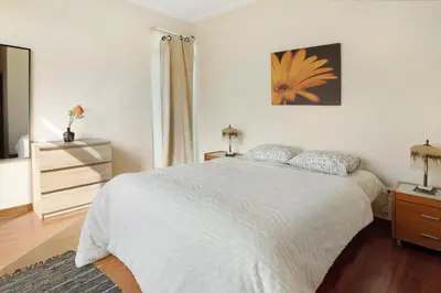 a bedroom with a bed and a dresser and a mirror at Madeira Villa Liliana in Campanário