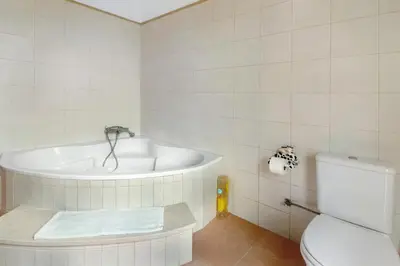 a bathroom with a sink and a vase of flowers at Madeira Villa Liliana in Campanário