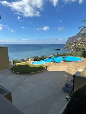 a view of a swimming pool and the ocean at Luxury Sea View Apartment in Funchal