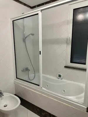 a bathroom with a shower and a toilet and a sink at Luxury Sea View Apartment in Funchal