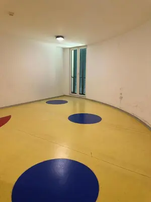an empty gym with blue mats on a wooden floor at Luxury Sea View Apartment in Funchal