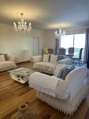 a living room with two couches and a chandelier at Luxury Sea View Apartment in Funchal