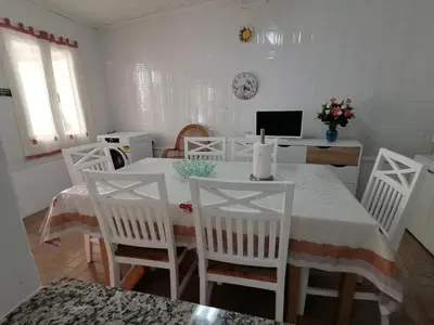 a kitchen with a stainless steel refrigerator next to a door at Westerland House in Ribeira Brava
