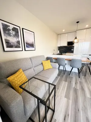 a living room with a couch and a glass table at Dona I Apartments at Botanical Garden in Funchal