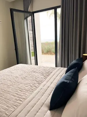 a bedroom with a large bed and a window at Dona I Apartments at Botanical Garden in Funchal