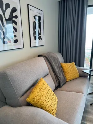 a living room with a couch and a table with chairs at Dona I Apartments at Botanical Garden in Funchal