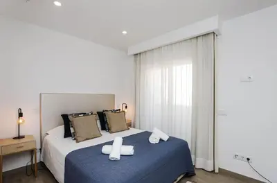 a bedroom with a bed with two crosses on it at 1Bed Apartment Amazing Sea View in Luz