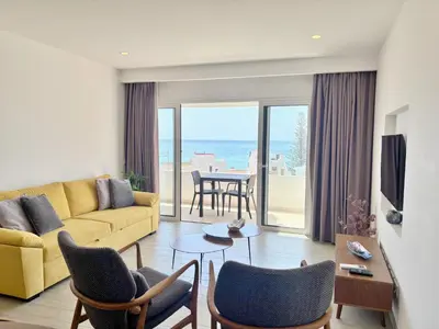 a living room with a yellow couch and chairs at 1Bed Apartment Amazing Sea View in Luz