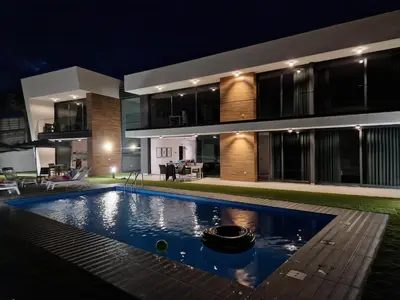 a house with a swimming pool at night at Vila Inanda in Ponta do Sol