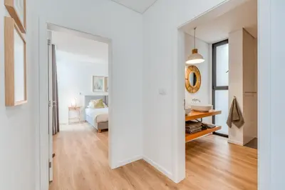 a room with a bed and a door leading to a bedroom at Vila Inanda in Ponta do Sol