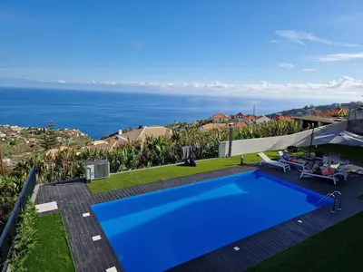 a swimming pool with a view of the ocean at Vila Inanda in Ponta do Sol