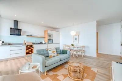 a living room with a couch and a kitchen at Vila Inanda in Ponta do Sol