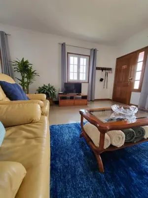 a living room with a couch and a coffee table at Villa Paradise Madeira Ocean View in Fajã da Ovelha