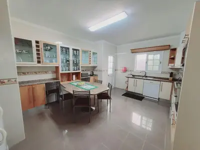 a large kitchen with a table and chairs in it at Villa Paradise Madeira Ocean View in Fajã da Ovelha