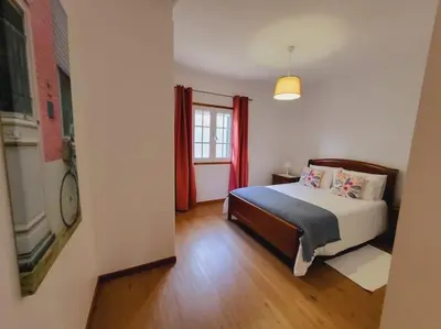 a bedroom with a bed and a window at Villa Paradise Madeira Ocean View in Fajã da Ovelha