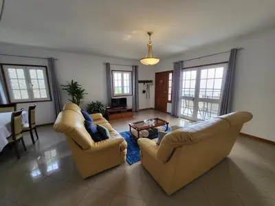 a living room with two couches and a table at Villa Paradise Madeira Ocean View in Fajã da Ovelha